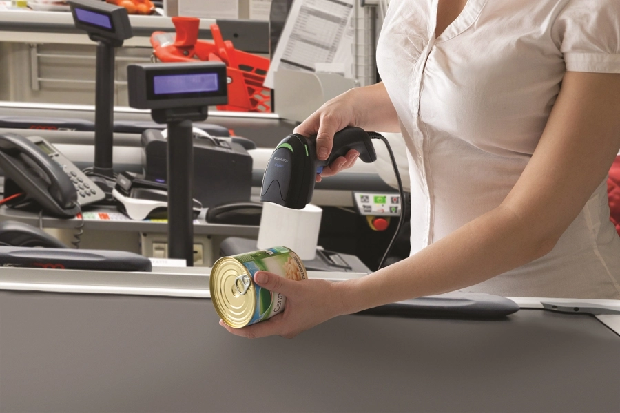 Datalogic Gryphon I GD4220 black corded USB 1D barcode scanner scanning a tin at a retail checkout for fast point-of-sale use