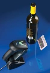 Refurbished Datalogic Gryphon GBT4400 wireless Bluetooth 1D/2D barcode scanner on USB dock, scanning a wine bottle label for retail, POS and logistics.