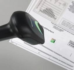 Refurbished Datalogic Gryphon GBT4400 wireless Bluetooth 1D/2D imager scanning a code on a document for POS, retail, warehouse and logistics use